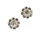 A pair of diamond set ear studs each claw set with an old round cut diamond, to post and tension