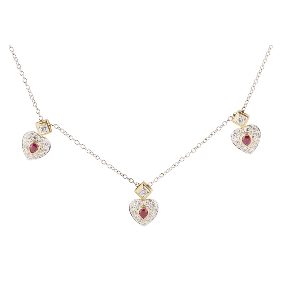 A ruby and diamond set cluster pendant composed of three heart shaped pendants set at intervals,