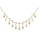 An Edwardian peridot and tourmaline set fringe necklace the trace link chain suspending eleven