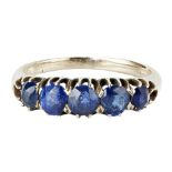 A five stone sapphire set ring claw set with five graduated sapphires, to a plain yellow metal