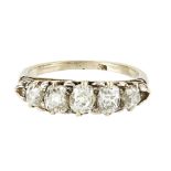 A five stone diamond set ring claw set with five graduated old round and oval cut diamonds,