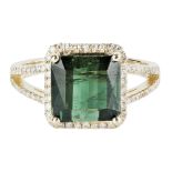 A green tourmaline and diamond set ring claw set with a mixed-square cut green tourmaline, in a