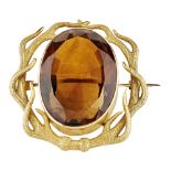 A citrine set brooch the oval cut citrine collet set in a stylised antler surround, unmarked Height: