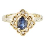 A sapphire and diamond set cluster ring claw set with an oval sapphire, in a border of round