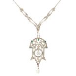 An early 20th century paste set pendant the stylised plaque with pierced foliate detail, set