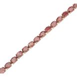 A tourmaline set line bracelet claw set with thirty oval cut pink tourmalines, to a lobster clasp