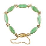 A jade set bracelet composed of seven marquise jade set links, the concealed clasp with pierced