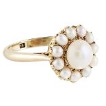 A SCOTTISH PEARL SET CLUSTER RING claw set with a central bouton pearl in a border of smaller