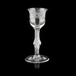 A JACOBITE ENGRAVED WINE GLASS 18TH CENTURY the shaped ogee bowl engraved with a band of fruiting