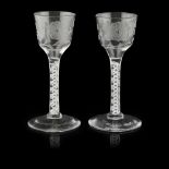 OF JACOBITE INTEREST, A PAIR OF ENAMEL-TWIST STEM WINE GLASSES with ogee bowls, engraved with rose