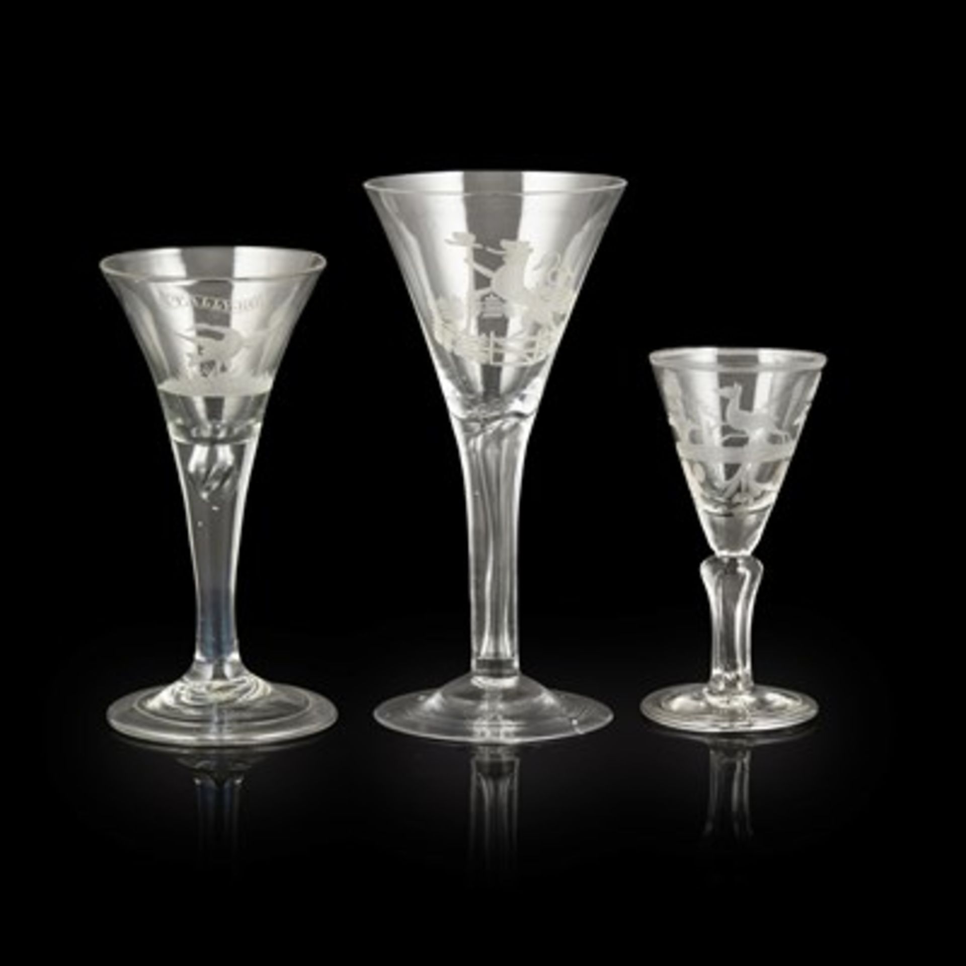 THREE GEORGIAN ENGRAVED WINE GLASSES 18TH CENTURY all with flared trumpet bowls, comprising a