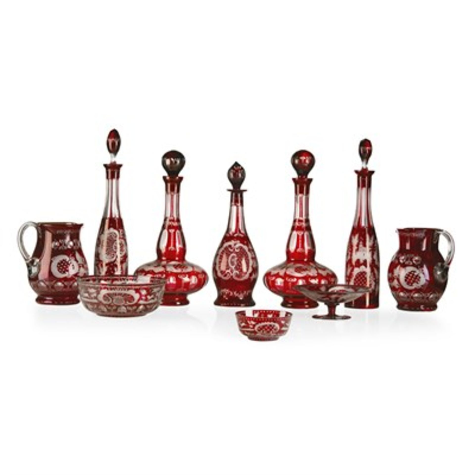 PART SUITE OF BOHEMIAN RED FLASH-CUT GLASS 19TH CENTURY with wheel-engraved cartouches, buildings,
