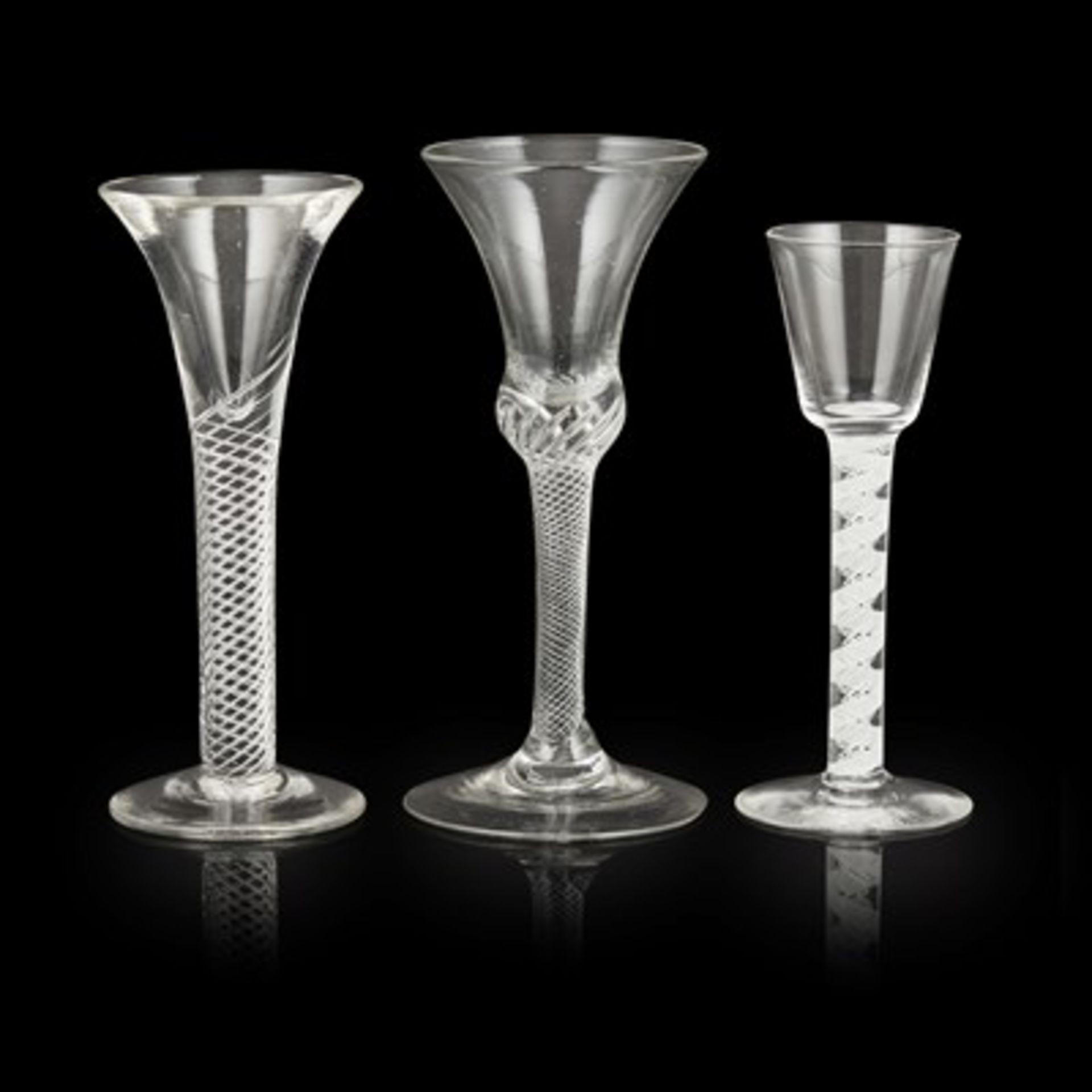 THREE GEORGIAN TWIST STEM WINE GLASSES MID-18TH CENTURY comprising two with trumpet bowls and air-