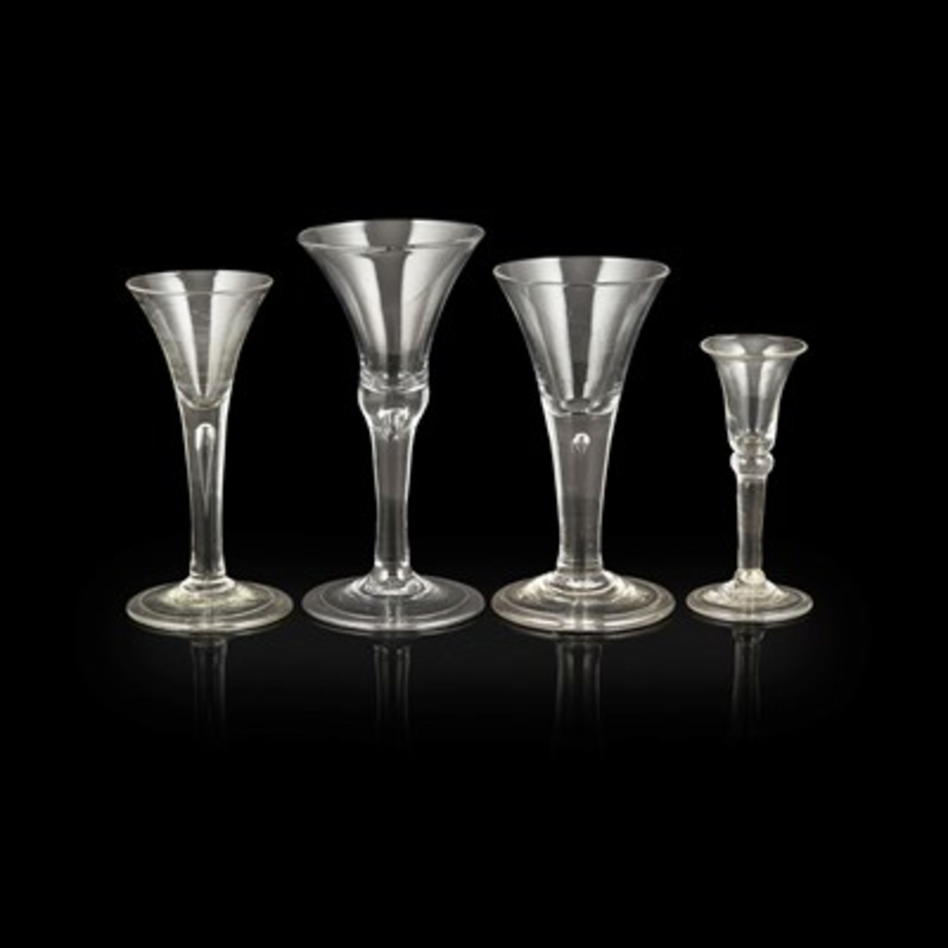 FOUR GEORGIAN WINE GLASSES 18TH CENTURY with trumpet and flared bowls, on plain stems, including two