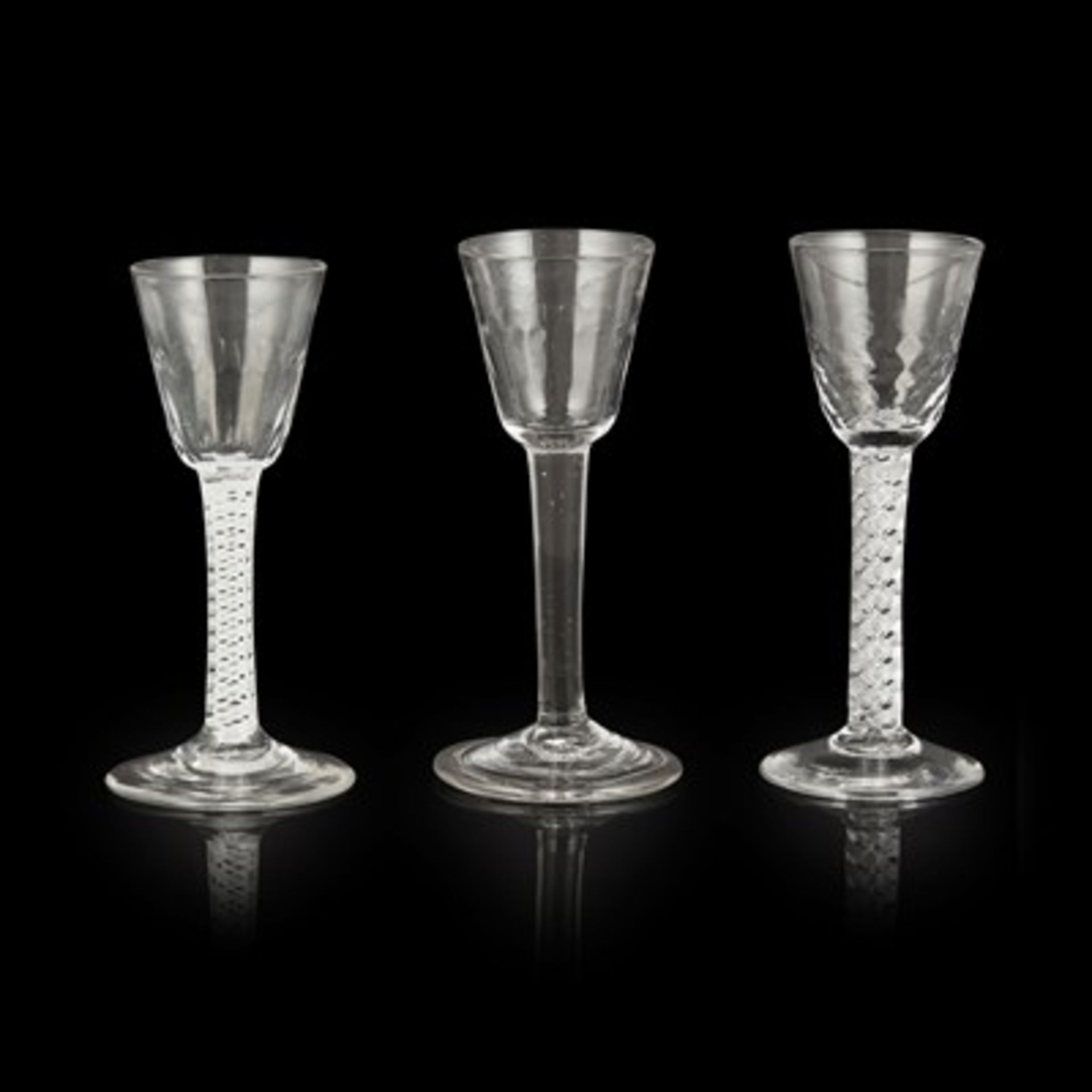 THREE GEORGIAN WINE GLASSES MID 18TH CENTURY all with hammered round funnel bowls, comprising one on