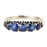 A five stone sapphire set ring claw set with five graduated sapphires, to a plain yellow metal