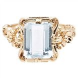 An aquamarine set ring claw set with a emerald-cut aquamarine, in a cast scrolling foliate mount,