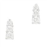A pair of diamond set earrings each claw set with three graduated round brilliant cut diamonds, to