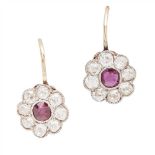 A pair of ruby and diamond set cluster earrings each millegrain set with a cushion cut ruby in a