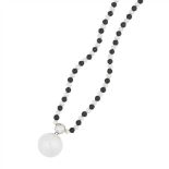 An onyx, pearl and diamond set necklace composed of an alternating row of pearls and onyx beads,