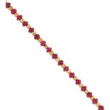 A ruby bead necklace comprised of twenty-four polished ruby beads of graduated sizes between faceted