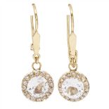 A pair of topaz and diamond cluster earrings each claw set with a round cut colourless topaz, in a