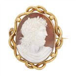 A large Victorian cameo brooch depicting a classical figure in profile, in an open scrolling