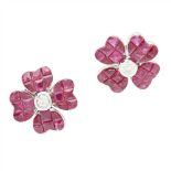 A pair of ruby and diamond set floral earrings each modelled as a flower, collet set with a round