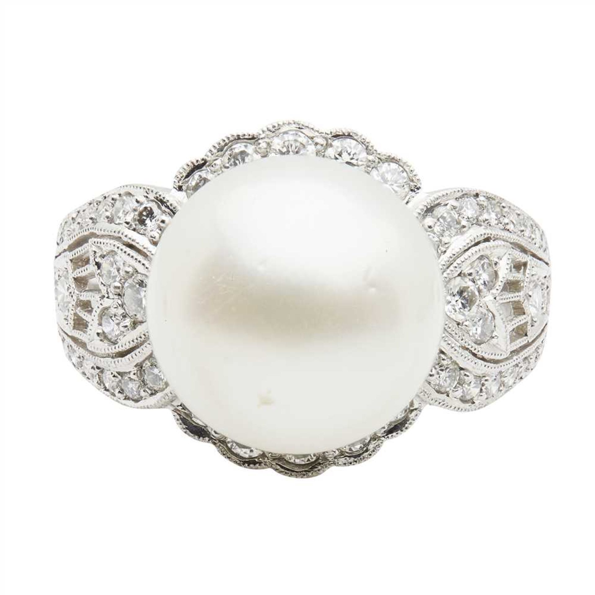 A South Sea pearl and diamond cocktail ring set with a large South Sea pearl, in a border of small