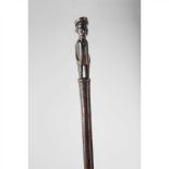 ZULU STAFF SOUTHERN AFRICA carved wood, with a finial depicting an officer in colonial dress, rich