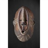 NGBAKA MASK DEMOCRATIC REPUBLIC OF CONGO carved wood and pigment, the oval face raised and with
