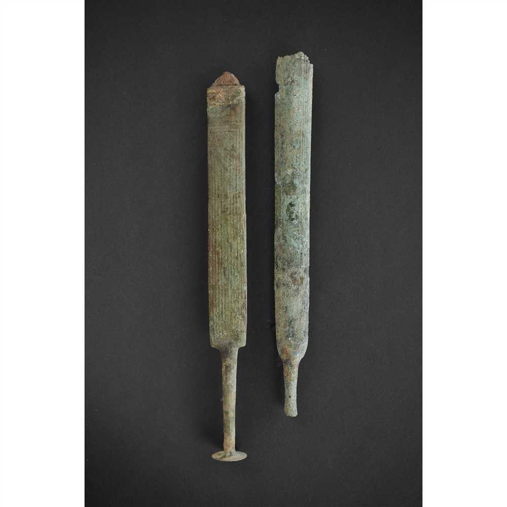 PAIR OF VILLANOVAN DAGGERS ITALY, 700 - 900 B.C. cast bronze and iron, both scabbards with
