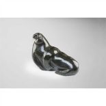 INUIT WALRUS CARVING CANADA soapstone, depicting a reclining walrus with marine ivory inset tusks