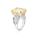 A yellow sapphire and diamond set cocktail ring