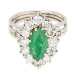 An emerald and diamond cluster ring