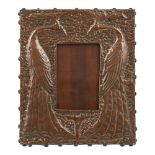 GLASGOW SCHOOL REPOUSSÉ COPPER ‘PEACOCK’ PHOTOGRAPH FRAME, CIRCA 1900 chased with a pair of opposing