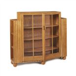 ATTRIBUTED TO HEAL & SON, LONDON OAK BOOKCASE CABINET, CIRCA 1930 the glazed doors opening to a