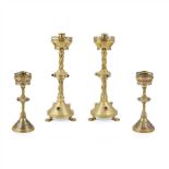 ENGLISH SCHOOL TWO PAIRS OF GOTHIC REVIVAL JEWELLED BRASS CANDLESTICKS, CIRCA 1880 each with broad