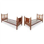 COTSWOLD SCHOOL PAIR OF ARTS & CRAFTS CARVED WALNUT SINGLE BEDS, CIRCA 1930 the headboards with