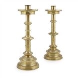 HARDMAN, POWELL & CO. PAIR OF GOTHIC REVIVAL BRASS ALTAR CANDLESTICKS, CIRCA 1885 each with a