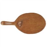 ROBERT 'MOUSEMAN' THOMPSON (1876-1955) OAK CHEESE BOARD, CIRCA 1940 of oval form with adzed