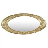 GLASGOW SCHOOL ARTS & CRAFTS CELTIC REVIVAL BRASS WALL MIRROR, CIRCA 1910 of oval outline,