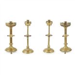 ENGLISH SCHOOL TWO PAIRS OF GOTHIC REVIVAL JEWELLED BRASS CANDLESTICKS, CIRCA 1880 each with broad