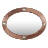 LIBERTY & CO., LONDON ARTS & CRAFTS COPPER WALL MIRROR, CIRCA 1900 the oval frame with hammered