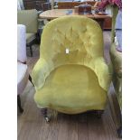 A Victorian buttonback ladies armchair, with turned tapering legs and pot castors