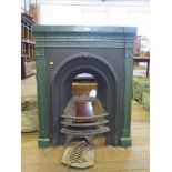 A cast-iron fireplace surround painted dark green with grate 99cm x 80cm