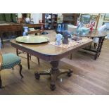 A Regency crossbanded mahogany breakfast table, the rectangular snaptop over a reeded stem on a