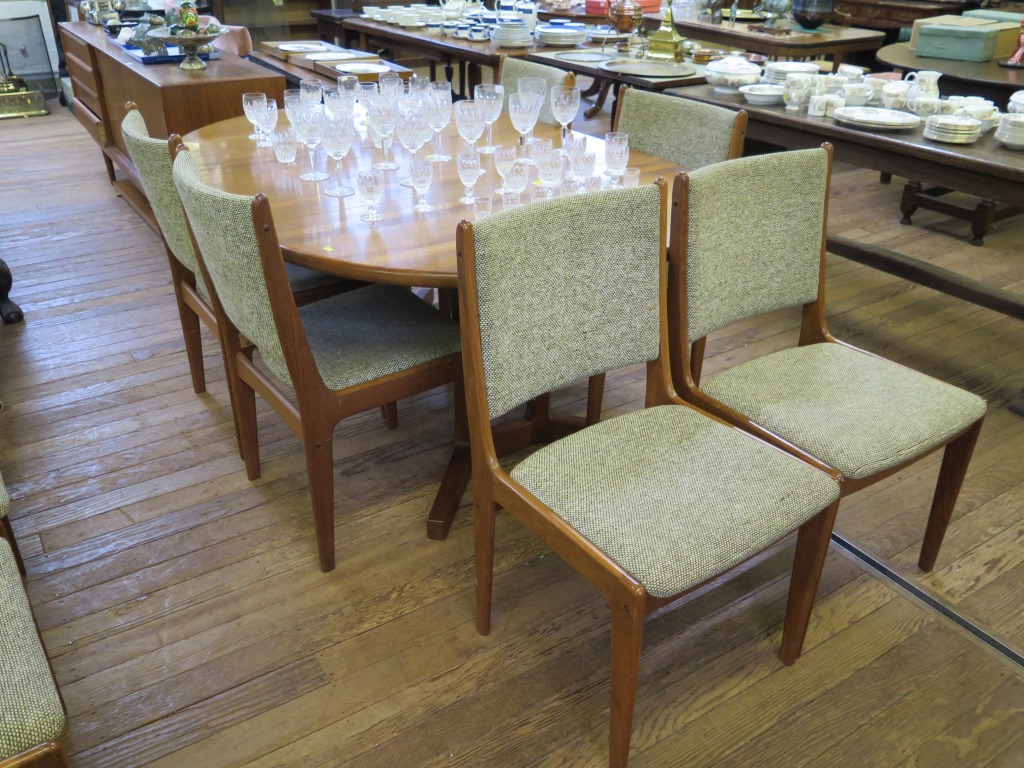 A 1970s teak dining room suite, comprising eight dining chairs, an extending dining table with two