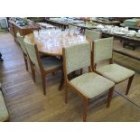 A 1970s teak dining room suite, comprising eight dining chairs, an extending dining table with two