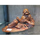 A Chinese hardwood figure of a reclining man with bats and basket 33cm long